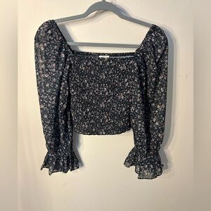 Cropped black fitted floral blouse.